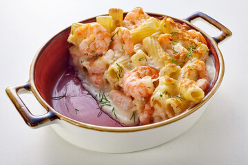 Tasty pasta with seafood baked in casserole and served on table