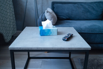 Blue tissue box on the bedside table in the bedroom, minimalism in the interior.