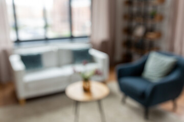 background and interior concept - blurred living room with furniture at home