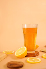 a glass of tea photographed suitable for beverages menu display. a tempting fresh drink with sliced orange decorated on orange background.