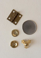 metal objects (metal corner, hinge, watch back)