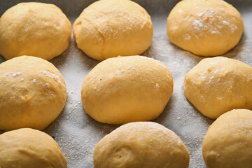 Fototapeta na wymiar Raw yeast dough balls background in frying pan before baking. Concept home baking bread, buns or cinnabon or making dough.
