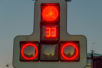A traffic light with red forbidding signals.