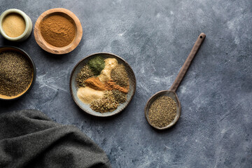 Top down view of an assortment of dry spices used to make a Greek seasoning.