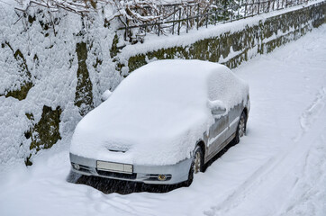 Car covered with snow on the street