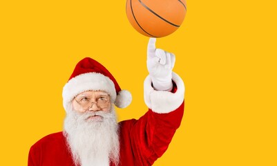 Cheerful Santa spinning of forefinger finger orange ball workout activity hobby background