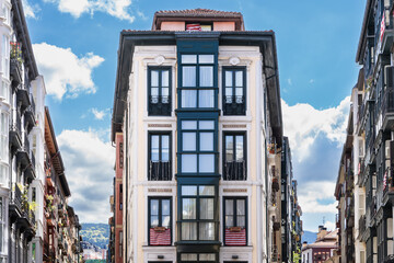 Bilbao old town street with residential houses facades in the city. Real estate business, classic...