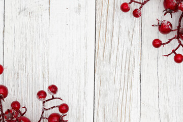 Christmas background with holly berry branch on grunge wood
