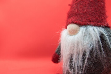 Old Christmas Gnome on Red Background with Free Space for Text. Winter Postcard with Scandinavian...