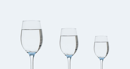 Three glasses of clean drinking water on a white background.