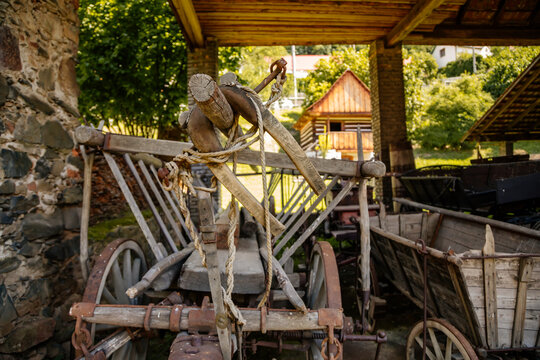Zbeсno, Central Bohemia, Czech Republic, 31 July 2021: Hamous Farm monuments of vernacular architecture, historic wooden building at summer sunny day, village at countryside, wooden cart and straw