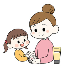 子供にハンドクリームを塗ってあげる母親