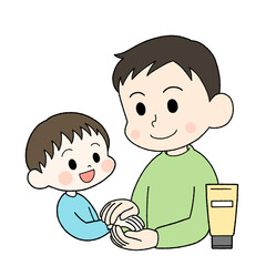 子供にハンドクリームを塗ってあげる父親