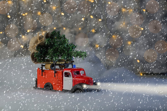 fire department vehicle carrying a christmas tree