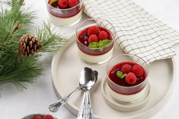 Italian dairy dessert panna cotta with raspberry jam and fresh raspberries on concrete tray