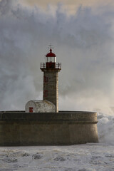 Fototapeta premium Stormy wave at old lighthouse