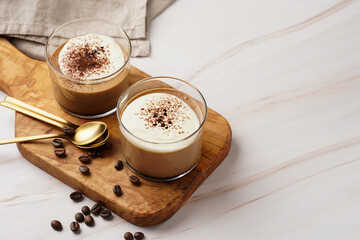 Italian chocolate and coffee mousse dessert semifreddo - half-frozen ice cream with whipped cream and cocoa powder in small glasses