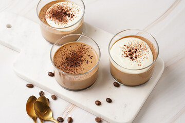Italian chocolate and coffee mousse dessert semifreddo - half-frozen ice cream with whipped cream and cocoa powder in small glasses
