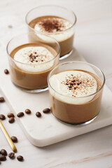 Italian chocolate and coffee mousse dessert semifreddo - half-frozen ice cream with whipped cream and cocoa powder in small glasses