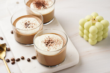 Italian chocolate and coffee mousse dessert semifreddo - half-frozen ice cream with whipped cream and cocoa powder in small glasses
