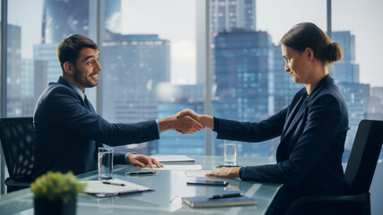 Female and Male Business Partners Sign Successful Deal Documents in Meeting Room Office. Corporate CEO and Investment Manager Agreed on a Lucrative Financial Opportunity.