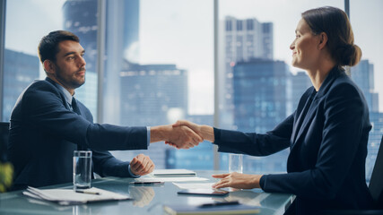 Female and Male Business Partners Sign Successful Deal Documents in Meeting Room Office. Corporate CEO and Investment Manager Agreed on a Lucrative Financial Opportunity.