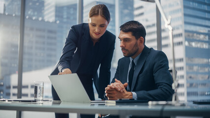 Successful Corporate CEO and Investment Manager Talking, Using Laptop Computer while Sitting in...