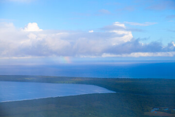 Coastal landscape with a rainbow on a rainy morning