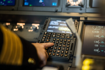 Female pilot inserting flight information into plane system. Airplane control panel.  © Михаил Решетников
