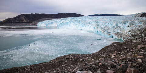 Landscape: Eqi glacier blue with blue ocean and rocks, Greenland  - obrazy, fototapety, plakaty