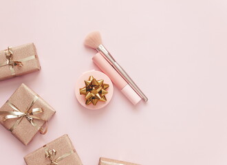 flat lay ,decorative cosmetics , gift boxes on pink background, top view, copy space.