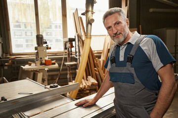 Portrait of delighted worker posing on camera