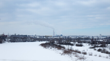 Fototapeta na wymiar Industrial area of the city in winter, heat production