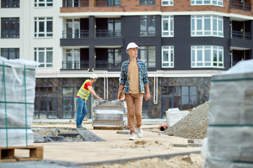 Man with tablet walking on construction site