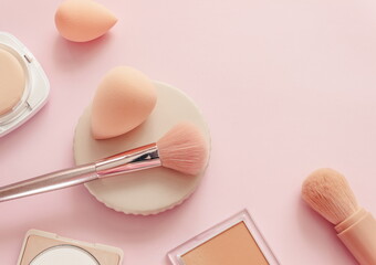 Makeup accessories, brushes and sponges,pink pastel background,flat layot