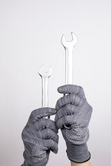 Wrenches in hands on a white background. Wrenches upright on a white background. Car service, equipment repair, sewerage repair