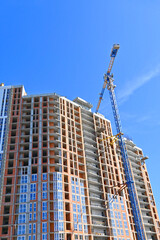 Fototapeta na wymiar Crane and highrise construction site