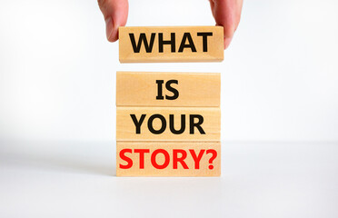 What is your story symbol. Concept words What is your story on wooden blocks. Businessman hand. Beautiful white table, white background, copy space. Business and what is your story concept.