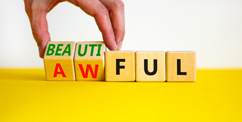 Beautiful or awful symbol. Businessman turns wooden cubes, changes the word Awful to Beautiful. Beautiful white background, copy space. Business, psychological beautiful or awful concept.