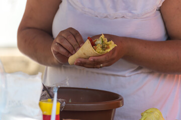 Marketplace with various food for sale. Eating on the street.