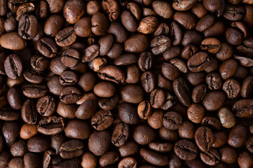 Coffee bean background. Roasted coffee beans on the entire surface. Brown coffee. Flat layout with top view. Close-up