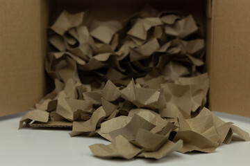 Closeup of two types of sustainable recycled paper package filler.