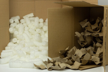 Closeup of two types of sustainable packing filler made of biodegradable starch and recycled paper. 