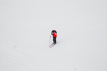 snowboarder is jumping with snowboard from snowhill. Skier skiing downhill in high mountains. Flying skier on mountains, winter extreme sport. 