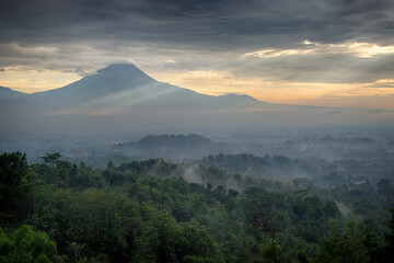 Fototapeta na wymiar Foggy dawn over Merapi and Borobudur