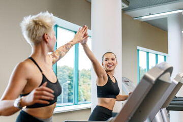 A young woman is doing fitness with a trainer at the GYM