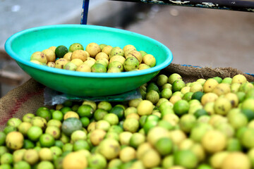 The selective focus of a few lemons in a basket.