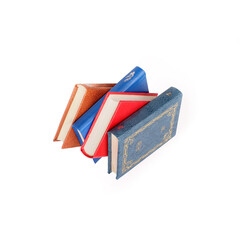 Red, brown and blue flying books isolated on a white background
