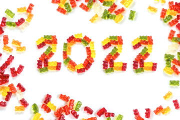 2022 made from colorful gummy bears and more gums around, sweet Happy New Year greeting card, isolated with small shadows on a white background