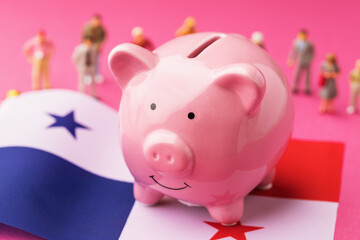 Piggy bank, Panama flag and plastic toy men on a colored background, concept on the theme of income of the population of Panama